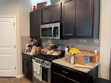 Kitchen featuring stainless steel appliances, bac