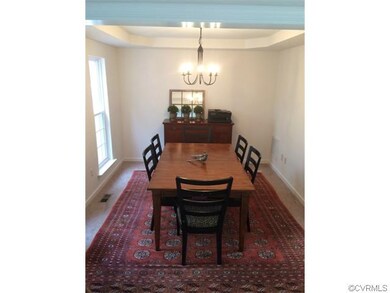 Dining room with a new chandelier, two windows and