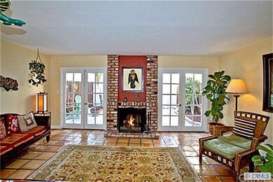 Family room w/fireplace opens to backyard with dua