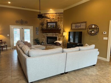 Living room with a fireplace, french doors, tile f