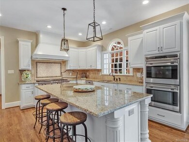 Kitchen showing double ovens. Wolf gas cooktop