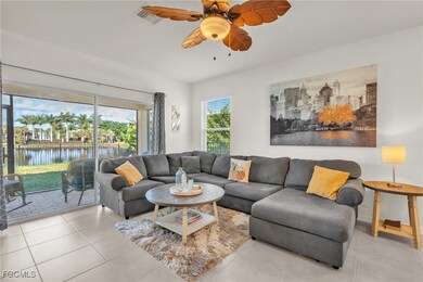 Tiled living room with a water view and a ceiling fan