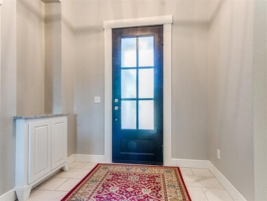 Doorway to outside featuring light tile patterned 