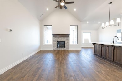 Unfurnished living room featuring a stone fireplac