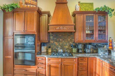 Designer Kitchen Cabinets With Rustic Backsplash A