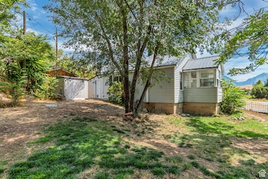 View of yard featuring a sunroom and a mountain view