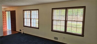 Spare room featuring plenty of natural light and c