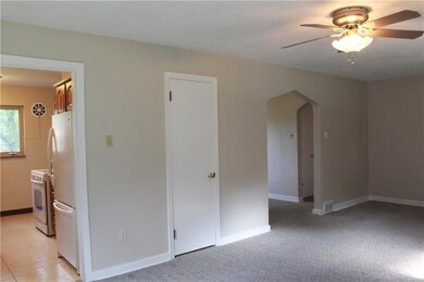 Living room with easy access to kitchen and dining