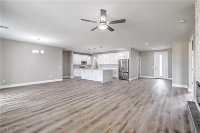 Unfurnished living room with baseboards, ceiling f