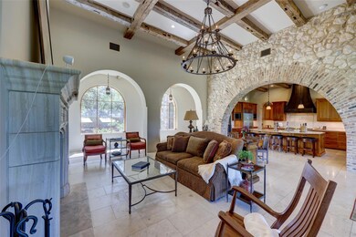 Living room with beam ceiling, visible vents, arc