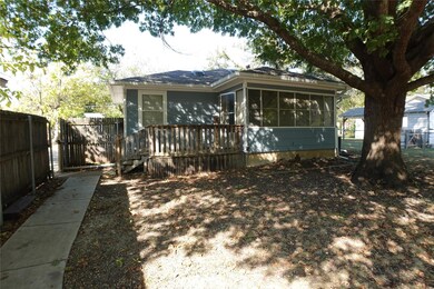Rear view of property featuring a deck and a sunro