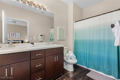 Full bathroom with wood finished floors, double va