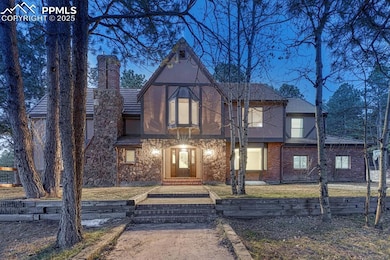 Tudor-style house featuring stucco siding and a ch