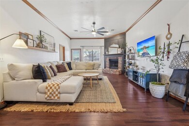 Living area featuring a fireplace, crown molding, 