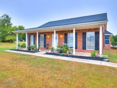View of front facade with a front yard and brick siding