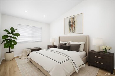 Virtually staged primary bedroom with attached ensuite bathroom. Vaulted ceilings and recessed lighting.