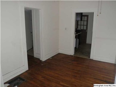 Dining area with entry to kitchen and hallway in b