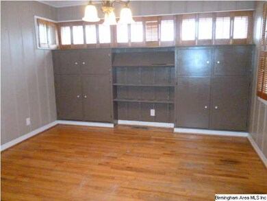 Dining room with wood flooring and lots of shelves