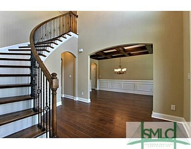 Foyer. Beautiful Curved Staircase invites you into