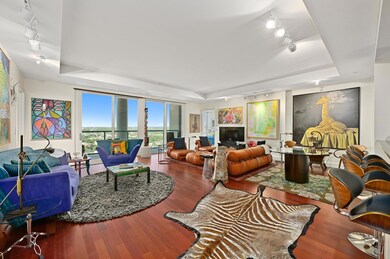 Living room with rail lighting, a tray ceiling, a