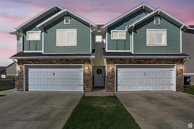 Craftsman house featuring stone siding, an attached garage, and board and batten siding