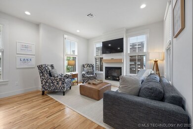 Living room with a fireplace, light wood finished