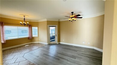 Spare room featuring crown molding, baseboards, ce