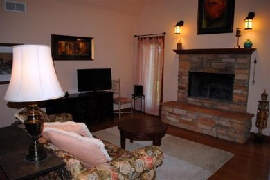 Great room offers bamboo hardwood floors, woodburning fireplace, and 15 ft vaulted ceiling.