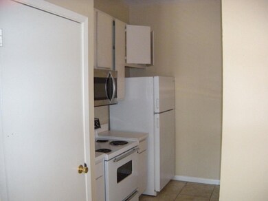 Kitchen featuring stainless steel microwave, ligh