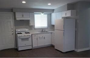 Kitchen with white appliances, light countertops,