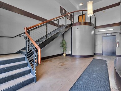 Stairs with a towering ceiling and concrete floori