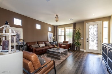 Living room with dark wood finished floors and baseboards