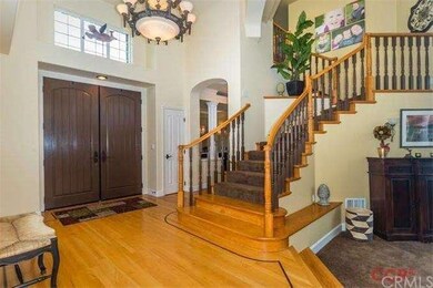 Grand entry with cathedral ceilings and wood floor