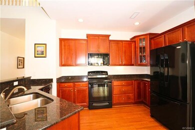 Kitchen with hardwood flooring and granite counter