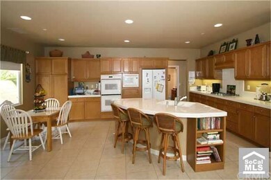 Kitchen with center island and breakfast bar.