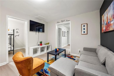 Living area with baseboards and wood finished floors