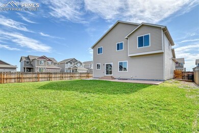 Large, level and fenced backyard with automatic sp