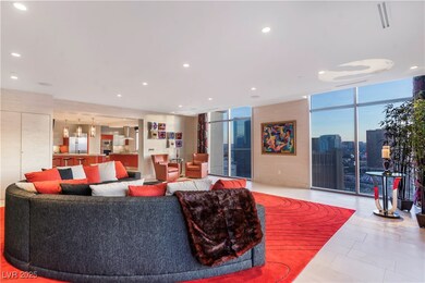 Living area with visible vents, a wall of windows,