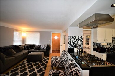 Check out this spacious living room with the view of this amazing kitchen area!