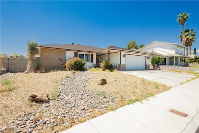 Single story home featuring a garage, concrete dri