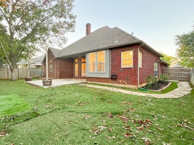 Back of property with a patio area and a lawn