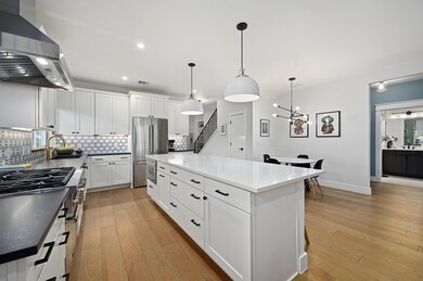 Kitchen featuring backsplash, wall chimney exhaus