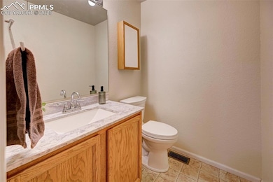 Main level Bathroom featuring vanity and toilet
