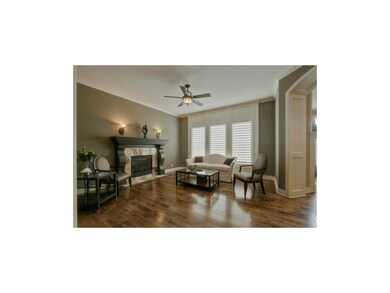 Spacious great room with fireplace and floor to ce