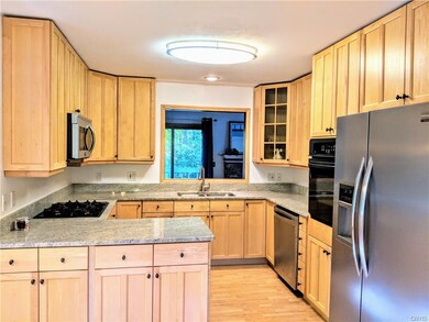 Fully updated kitchen features newer cabinets, gra