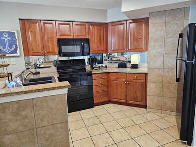 Kitchen featuring a sink, brown cabinetry, light t