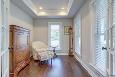 Home office/sitting room boasts a tray ceiling and