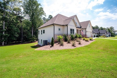 View of side of property featuring a yard, central