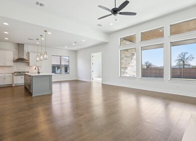 Kitchen featuring visible vents, dark wood-style 