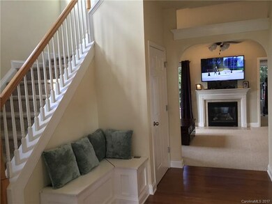 TWO-STORY FOYER WITH BUILT-IN SEATING. ARCHWAY TO 